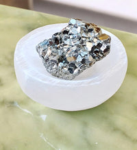 Pyrite Stone Cluster for Manifesting Financial Abundance with Selenite Bowl and White Sage Leaves
